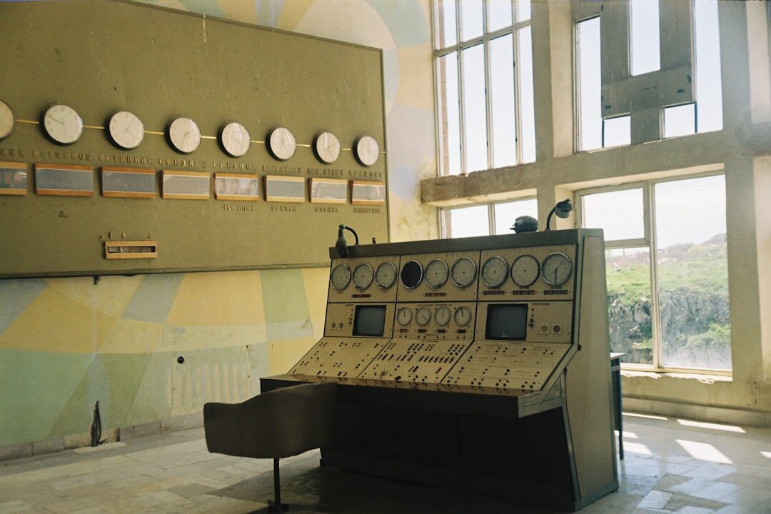 Analogue television control room with a wall of monitors and mixing console