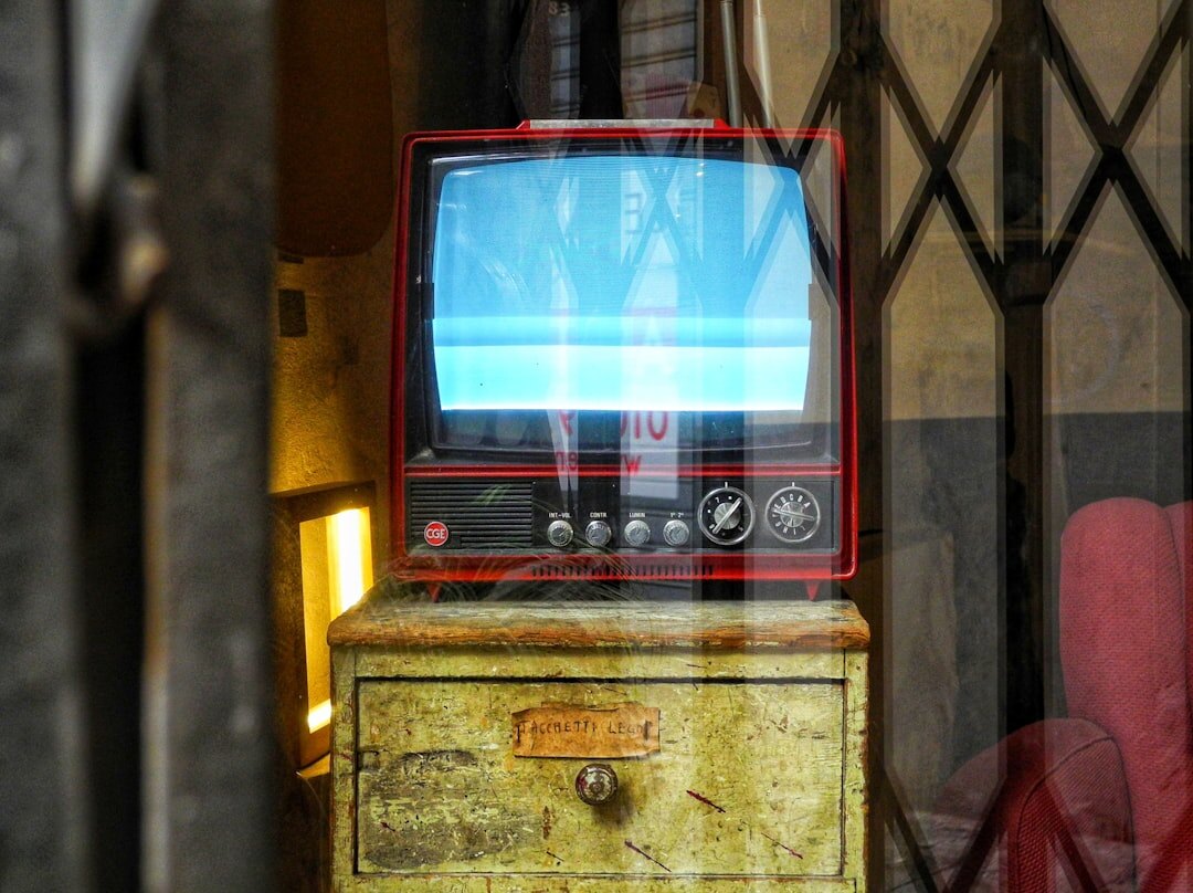Close-up of a vintage broadcast television camera on a studio pedestal